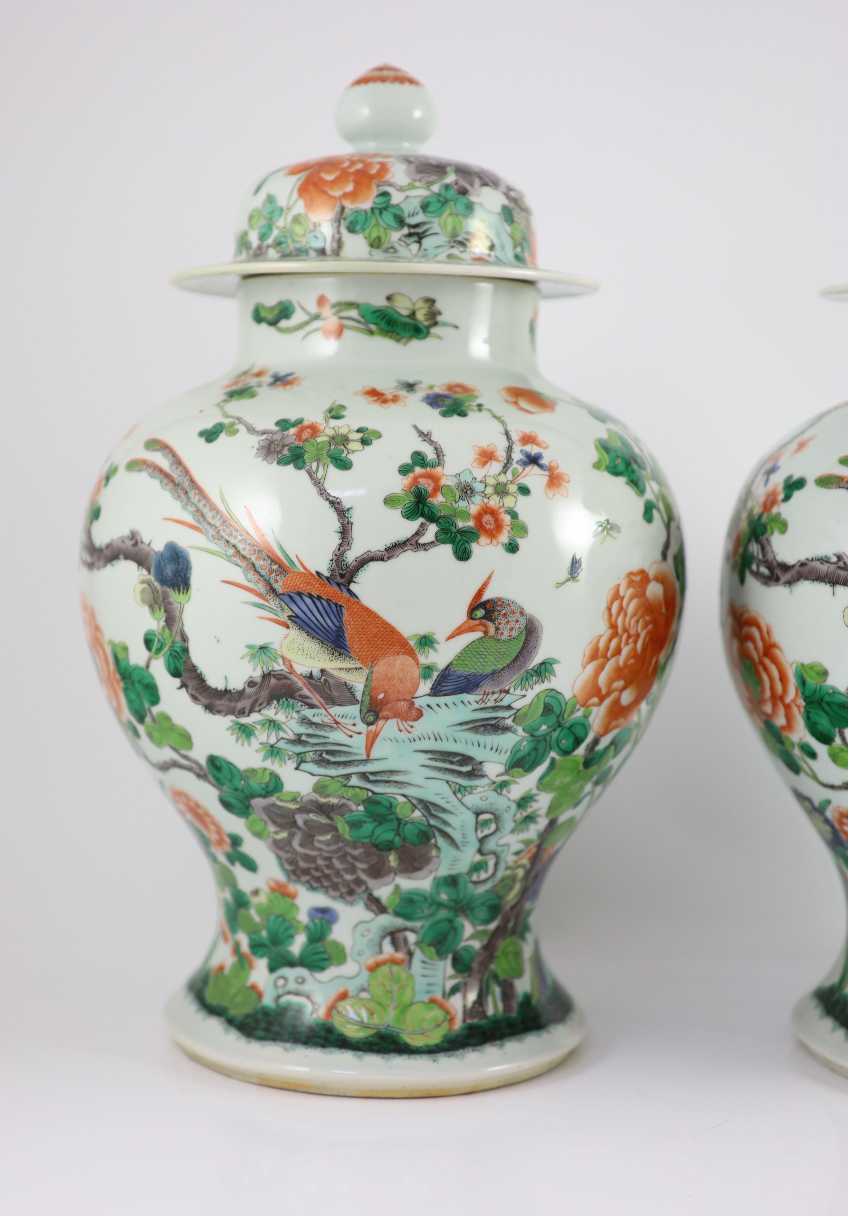 A pair of large Chinese famille verte jars and covers, late 19th century, 45cm high, restoration